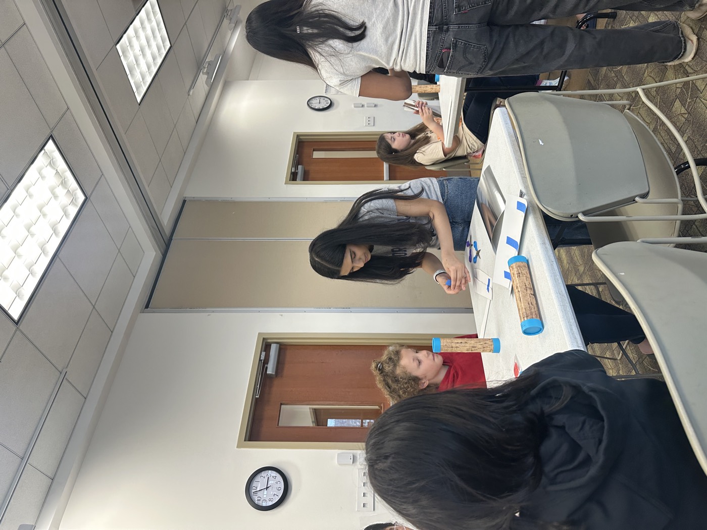 A student volunteer preparing materials during a workshop